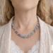 Model wearing Morning Mist Kumihimo Necklace, handmade beaded necklace in soft blue, mauve and silver tones with a pop of white